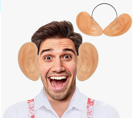 A man laughing with big plastic ears on